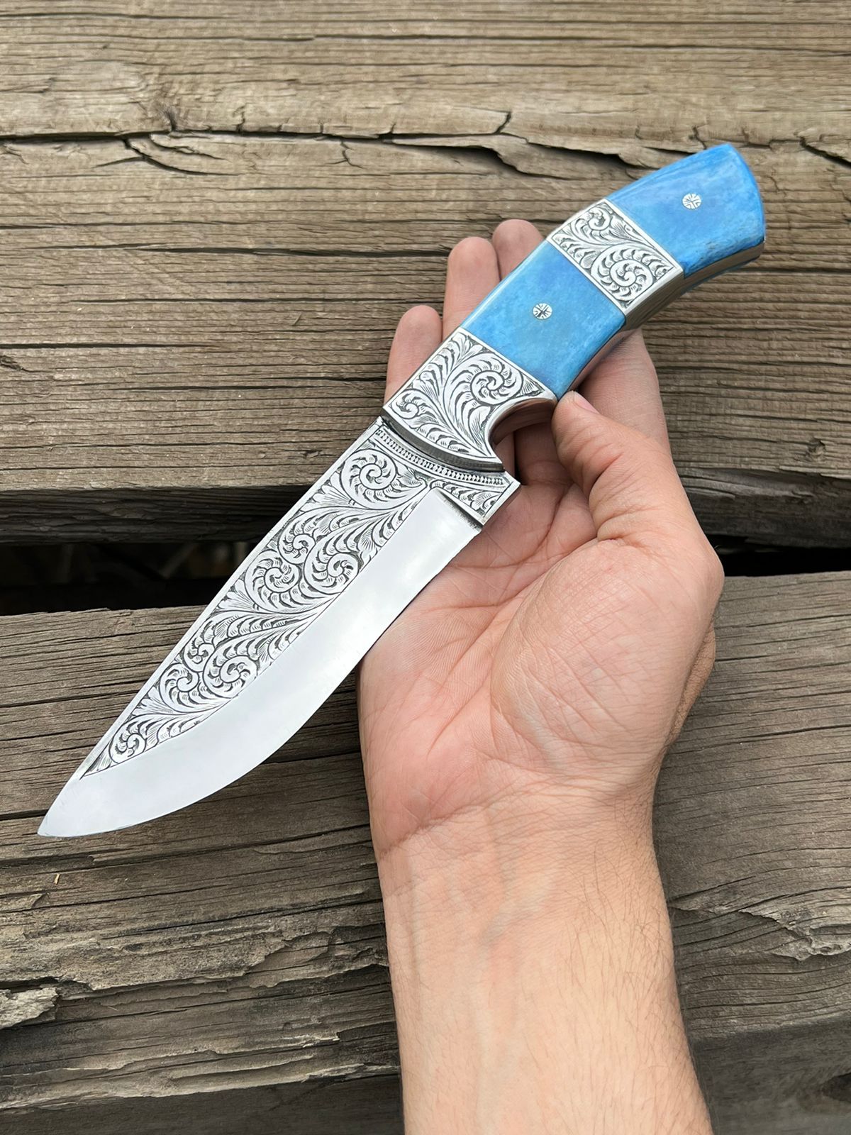 Custom hand-engraved hunting knife featuring a stainless steel blade and a beautifully crafted wooden handle with intricate engraving. This high-quality knife is perfect for hunting and outdoor activities and makes for a unique and stylish addition to any collection."