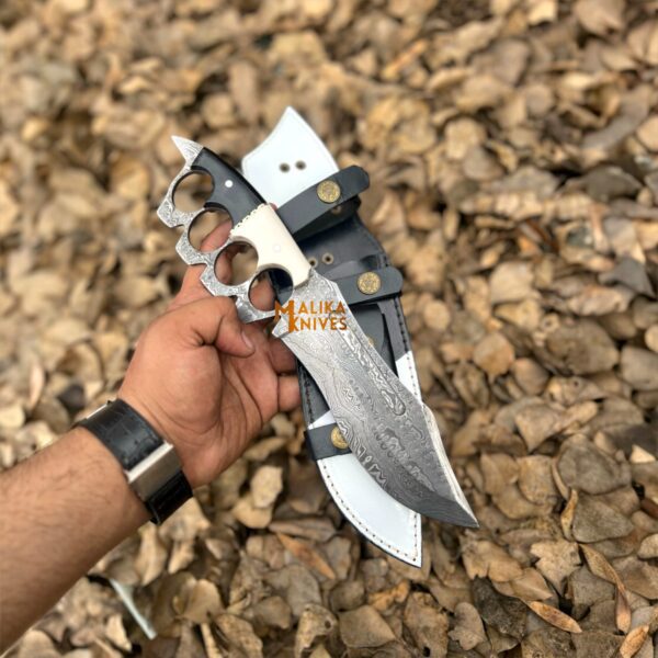 Damascus Knuckle Bowie Knife with black and white resin handle, full tang build, and drop point Damascus blade.